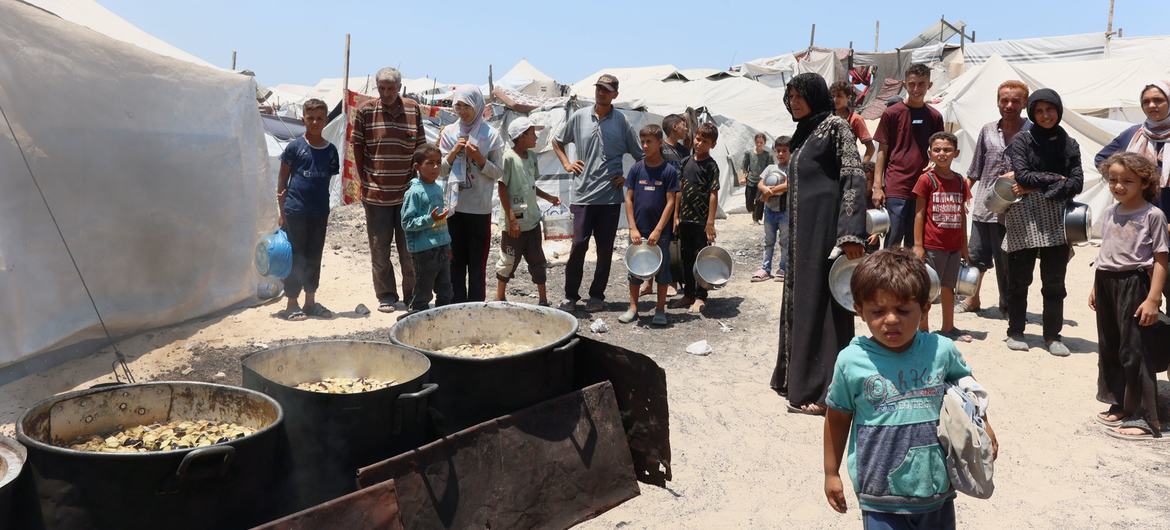 Gaza families at a food distribution point in a refugee camp
